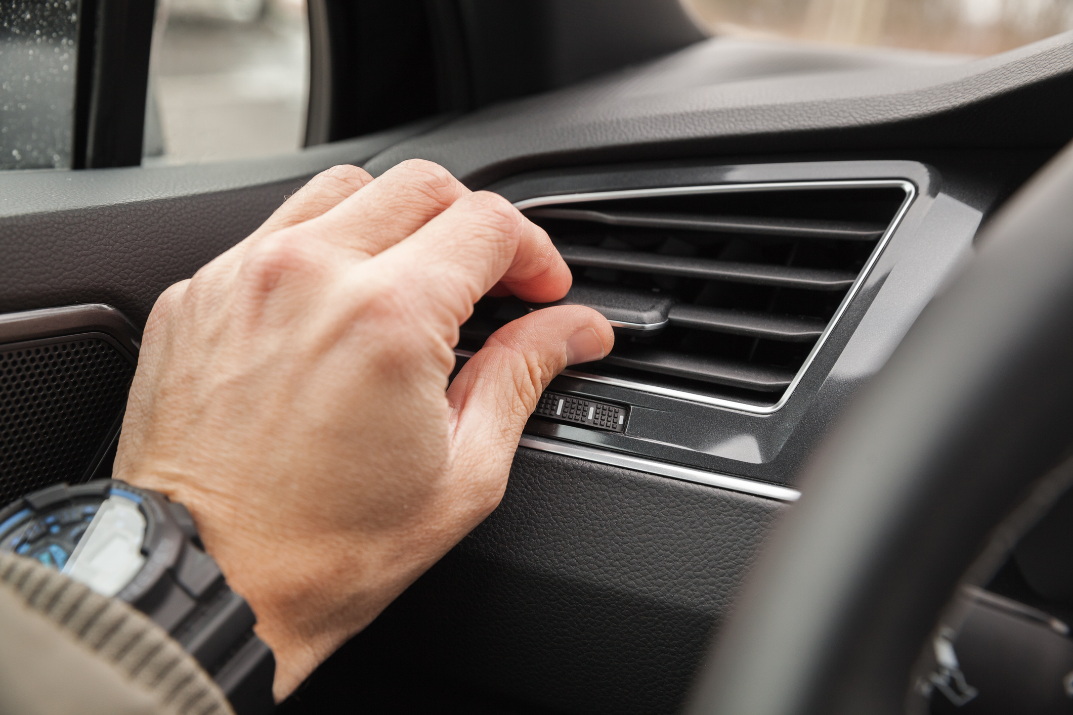 Driver adjusting A/C vent, checking to see if it needs repair.
