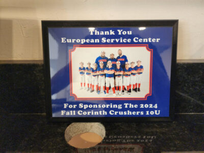 European Service Center recognized for sponsoring the 2024 Fall Corinth Crushers 10U youth baseball team, framed appreciation photo.